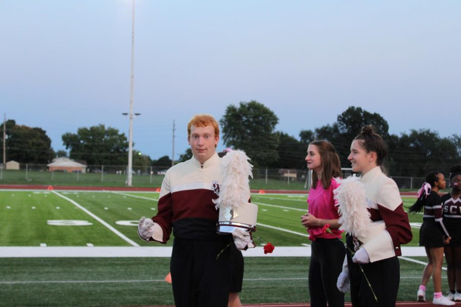 Senior band member Josh Huster is pictured with senior Hannah Kean, being escorted by freshman Annabelle Prost.