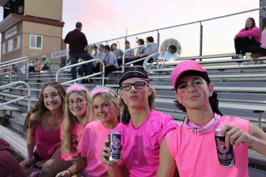 Freshmen Elizabeth Pellow and Matthew Box seated with sophomores Ryan Beer, Cadie Kohenskey, and Dayleigh Bullock before the game.