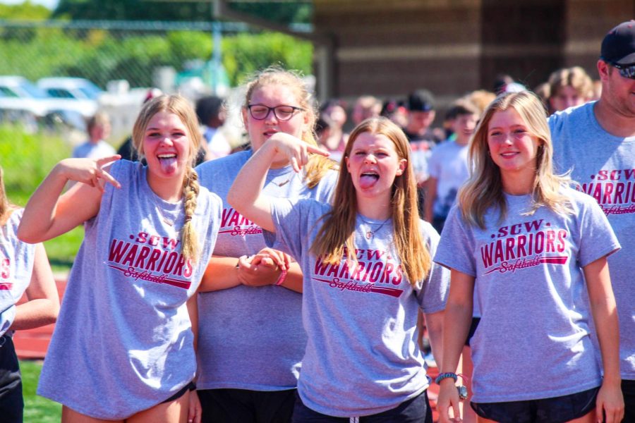 Freshmen Addie Miller, Alison Loftus with sophomore Delaney Little and junior Lauren Arender posing for the camera during the walk for athletes.