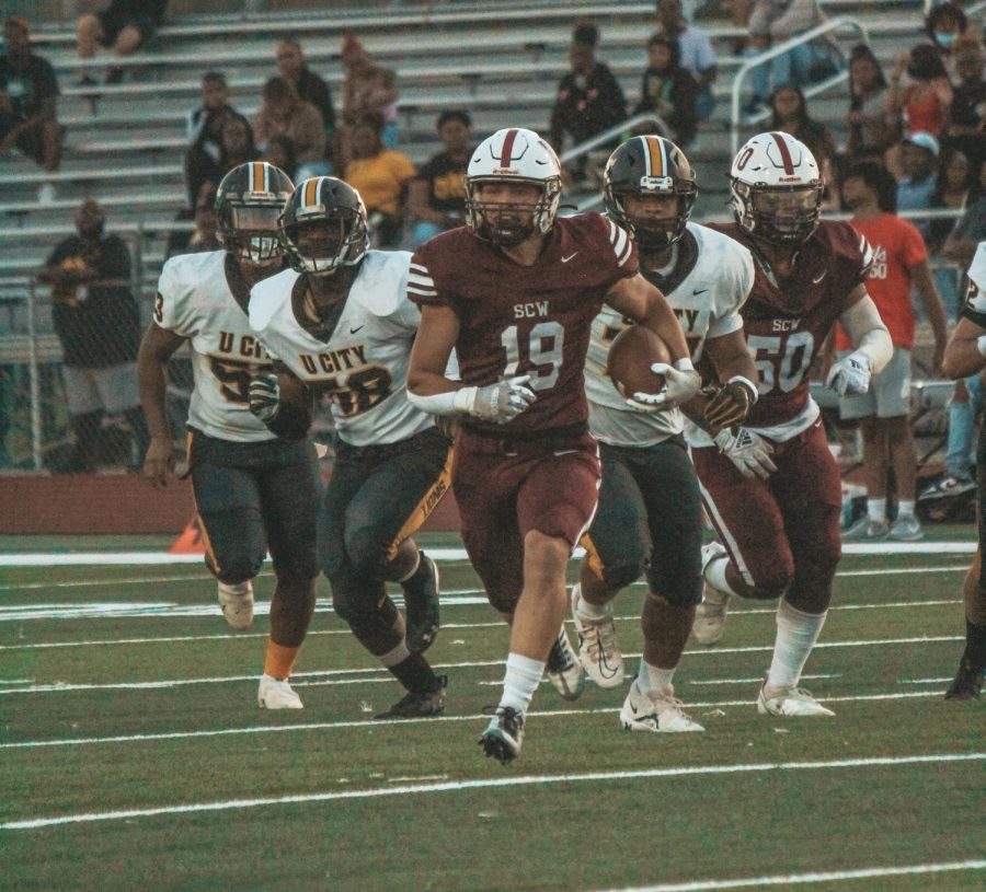 Senior Jacob Kirt running away from the University City Lions in an effort to get a first down on September 9, 2022.